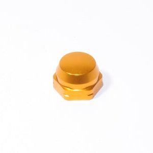 Die Avail Shimano Griffsicherungsmutter M7 in Orange, die für Original-Shimano-Kurbeln entwickelt wurde, ist auf einem schlichten weißen Hintergrund mit glatter, flacher Oberseite und leicht abgerundeten Kanten abgebildet.