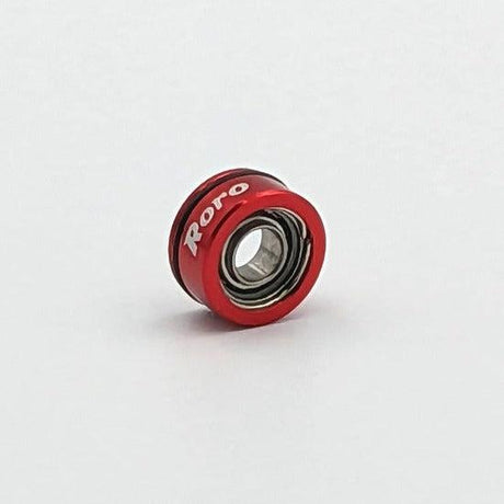 Ein kleiner roter Roro-Köder aus Metall von BFS Keramik Kugellager mit "Roro" in weißer Schrift auf dem Rand, abgebildet auf einem schlichten weißen Hintergrund.