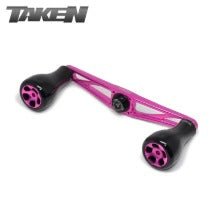 A rosa Taken AZ100 Handle - Power Handle aus Duraluminium mit H7 Knobs für Shimano & Daiwa, mit zentralem Montageloch, auf weißem Hintergrund und Taken-Logo oben links.