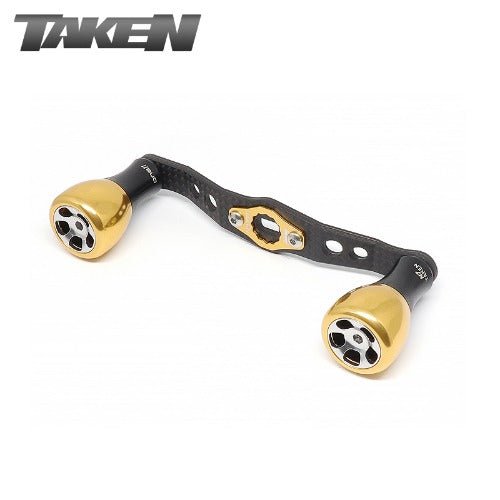 Der Taken H7 SS Crossover Carbon Griff 100 mm in Gold ist mit H7 Aluminium Knobs ausgestattet und passt auf Shimano und Daiwa Rollen, mit dem Taken Markenzeichen.