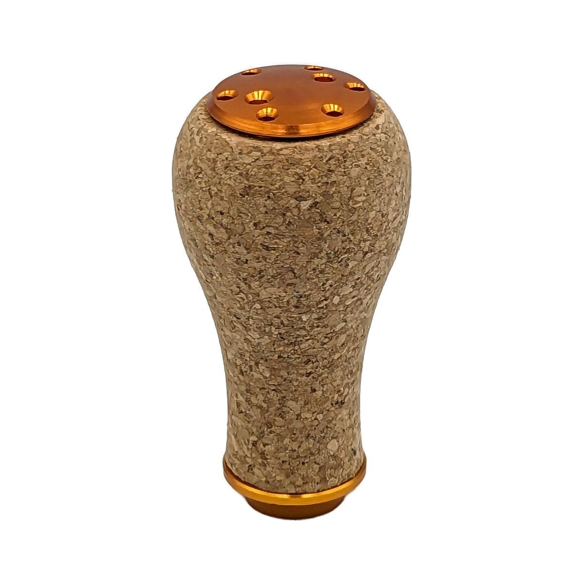 Der SLP Works Power Light Cork Knob S von SLP Works hat einen abgerundeten Korkgriff mit orangefarbenen Enden und kreisförmigen, gleichmäßig verteilten Löchern - ideal für Baitcasting-Rollen.