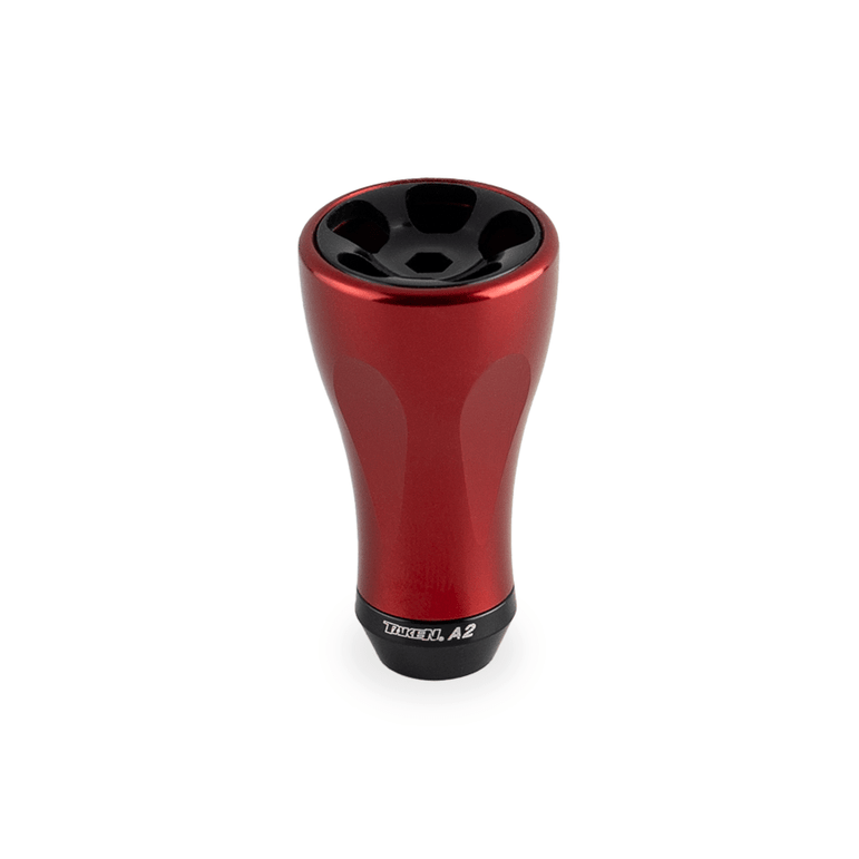 Ein rotfarbenes Taken A2 Knob 36mm - Tuning Aluminium Knauf für Shimano & Daiwa Angelrollen steht aufrecht vor weißem Hintergrund. Das glatte, sich verjüngende Design zeigt das Brand-Label 