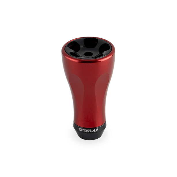 Ein rotfarbenes Taken A2 Knob 36mm - Tuning Aluminium Knauf für Shimano & Daiwa Angelrollen steht aufrecht vor weißem Hintergrund. Das glatte, sich verjüngende Design zeigt das Brand-Label "Taken" an der Basis.