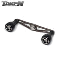Der Taken AZ100 Handle - Power Handle aus Duraluminium mit H7 Knobs für Shimano & Daiwa in Gunmetal ist auf einem weißen Hintergrund abgebildet, mit dem Taken-Logo in der oberen linken Ecke.