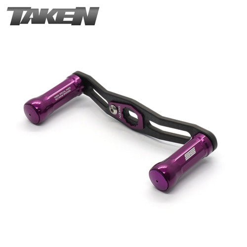 Ein Taken SS Carbon Handle 85 mm in lila mit zwei zylindrischen Aluminiumknöpfen für Shimano & Daiwa, dargestellt auf weißem Hintergrund. Der Markenname Taken erscheint in der oberen linken Ecke.