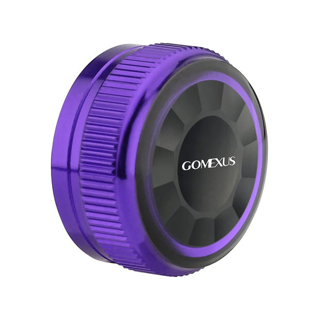 Eine runde, lilafarbene und schwarze Gomexus-Aluminiumkappe für den Spulenspannungsknopf mit geriffelter Kante und der Aufschrift "GOMEXUS Spool Tension Knob" in Weiß, entworfen für Shimano 20/22/23 Metanium Baitcaster.