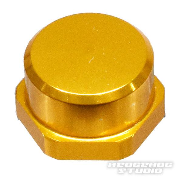 Die Hedgehog Studio Shimano Kurbel-Kontermutter M7 ist eine goldene sechseckige Duraluminiumkappe mit glatter, runder Oberseite und dem HEDGEHOG STUDIO Logo. Sie eignet sich perfekt als Ersatz für originale Shimano Kurbel-Kontermuttern.